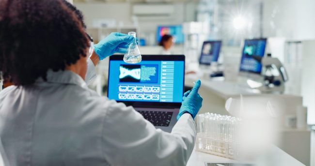 Lab, back and woman for science research, bio technology and gene mutation with laptop for data analysis. Bioinformatics, innovation study and beaker with chemical, life expansion and development