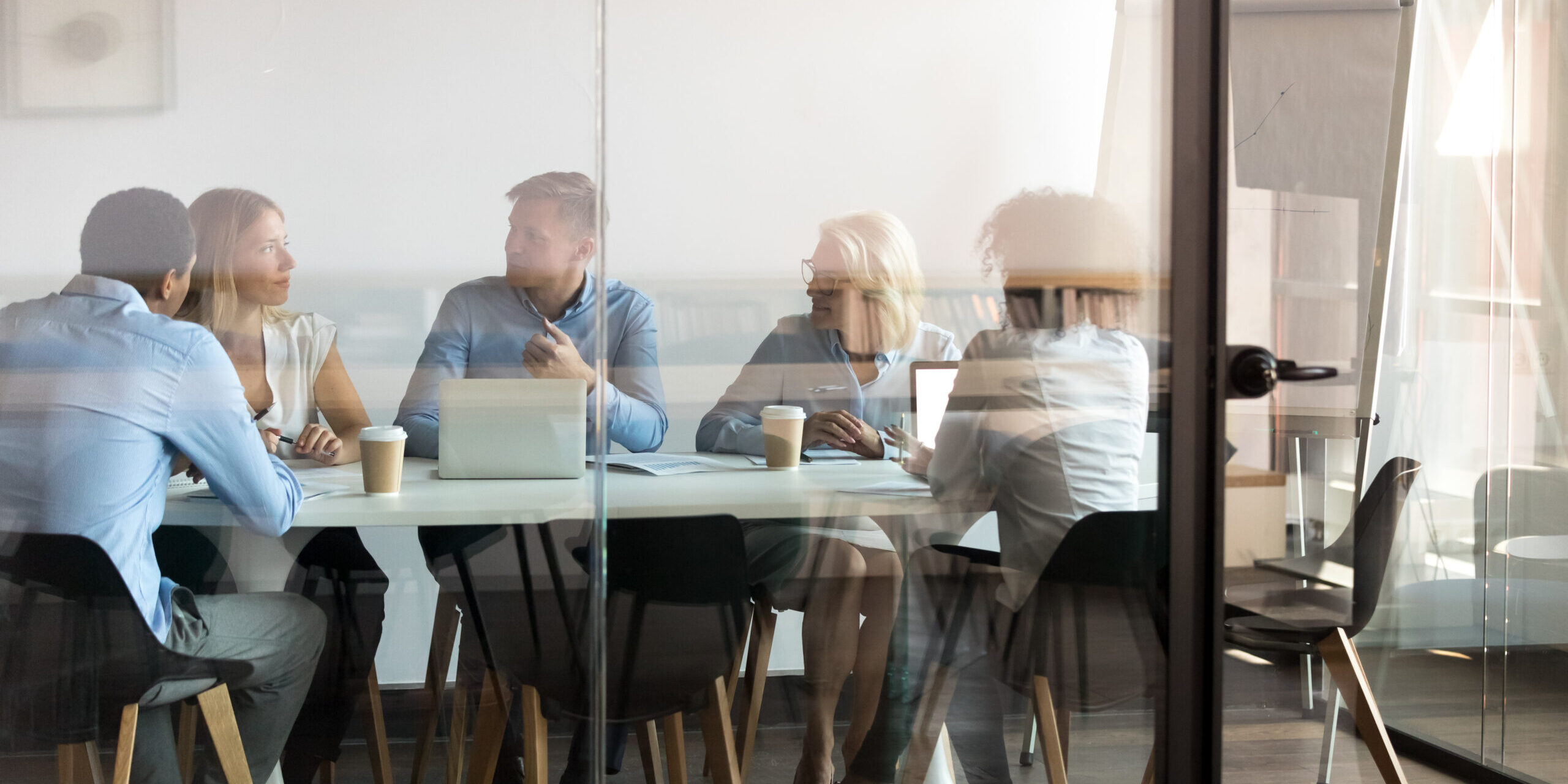 Business people negotiating at boardroom behind closed doors